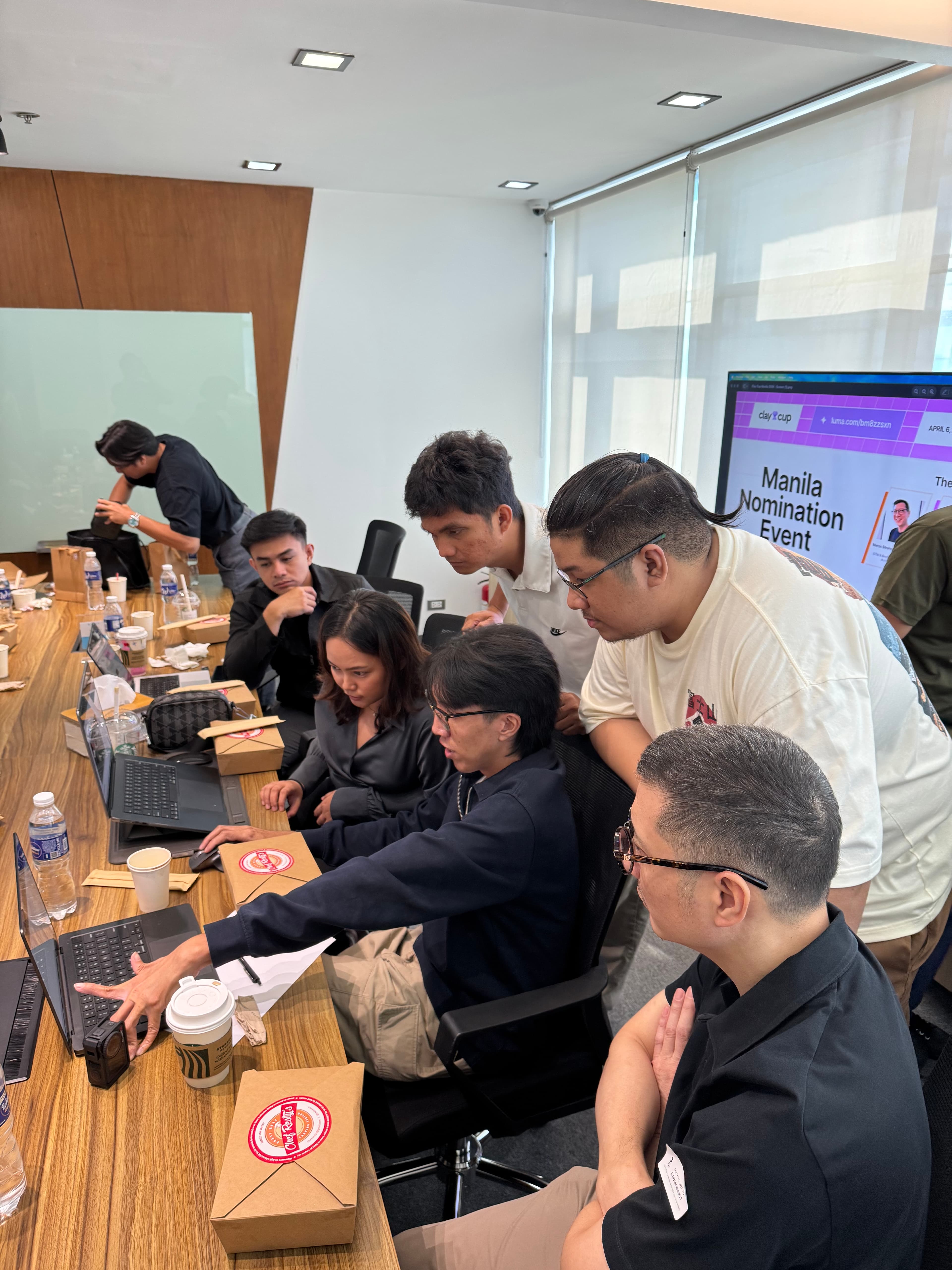 Clay Cup Manila competitors huddled over a laptop during the 20-minute GTM challenge at LOFT Spaces Eastwood Quezon City